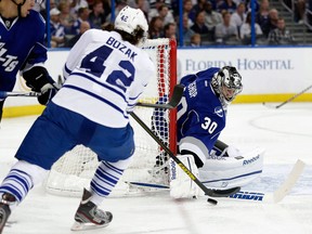 Tampa Bay Lightning goalie Ben Bishop, right, makes a stick save on Toronto's Tyler Bozak Wednesday. (AP Photo/Chris O'Meara)