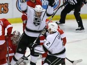 Los Angeles winger Kyle Clifford, centre, celebrates his goal on Detroit goalie Jimmy Howard. (AP Photo/Carlos Osorio)