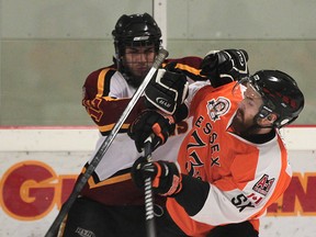 Grimsby's Cooper Nauboris, left, collides with Essex's Adam Dunmore at Essex Arena. (DAN JANISSE/The Windsor Star)