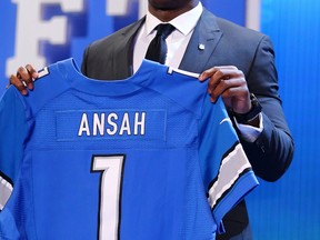 Ezekiel Ansah of the BYU Cougars holds up a jersey on stage after he was picked fifth overall by the Detroit Lions in the first round of the 2013 NFL Draft at Radio City Music Hall in New York City.  (Photo by Al Bello/Getty Images)