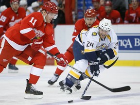 Nashville's Matt Halischuk, right, tries to take the puck from Detroit's Daniel Cleary at Joe Louis Arena. (Photo by Tom Szczerbowski/Getty Images)