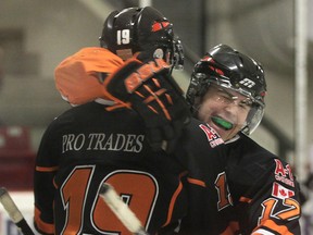 Essex's Scott Bromley, left, and Matthew Hebert celebrate a goal against Dresden at Essex Arena. (DAN JANISSE/The Windsor Star)