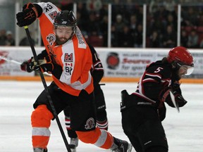 Essex's Adam Dunmore, left, is checked by Picton's Braeden Walsh during Game 4 of the Schmalz Cup at Essex Memorial Arena Sunday. (DAX MELMER/The Windsor Star)