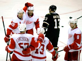 Detroit's Henrik Zetterberg, top centre, Niklas Kronwall, top left, Jonathan Ericsson, from left, Pavel Datsyuk and Justin Abdelkader celebrate a goal during the third period in Dallas Saturday. (AP Photo/Matt Strasen)