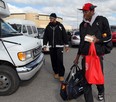 Windsor Express players Eric Parker, left, and Daniel Rose board an airport shuttle on their way to Game 5 of their playoff series against the  Summerside Storm Monday. (NICK BRANCACCIO/The Windsor Star)