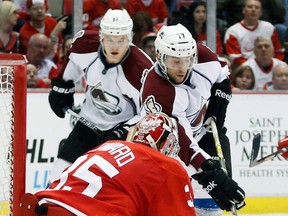 Colorado's Aaron Palushaj, right, tries to score on goalie Jimmy Howard as Jamie McGinn, left, watches in the first period Monday in Detroit. (AP Photo/Duane Burleson)