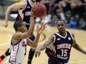 Windsor's Darren Duncan, left, lobs a pass into the paint over Summerside's Brandon Robinson at the WFCU Centre. (NICK BRANCACCIO/The Windsor Star)