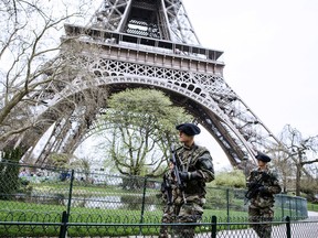 French soldiers patrol on April 16, 2013 in front of the Eiffel Tower in Paris. France on April 16 ordered police patrols to be stepped up after at least two people were killed and 23 others wounded in two explosions on April 15 near the finish line of the Boston Marathon.  AFP PHOTO / FRED DUFOURFRED DUFOUR/AFP/Getty Images