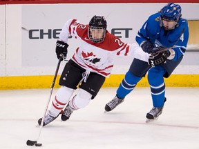 Ruthven's Meghan Agosta-Marciano, left, holds off Finland's Rosa Lindstedt at the IIHF Women's World Ice Hockey championships in Ottawa. (THE CANADIAN PRESS/Adrian Wyld)