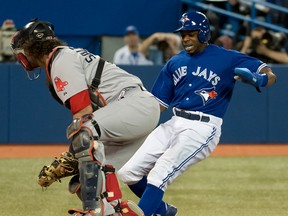 Toronto's Rajai Davis, right, scores a run in front of Boston catcher Jarrod Saltalamacchia at the Rogers Centre. [Peter J. Thompson/National Post]