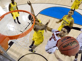 Louisville's Peyton Siva, right, drives for a shot against Michigan's Glenn Robinson during the NCAA Men's Final Four Championship at the Georgia Dome in Atlanta. (Photo by Chris SteppigPool/Getty Images)