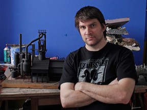 Toronto filmmaker Adam Makarenko is shown in his studo with a model of a steel mill. A cinematographer and miniature maker, Makarenko is trying to make a documentary of the infamous Windsor Hum - which has long been suspected of originating from the industrial facilities on Zug Island. (Adam Makarenko / Special to The Star)