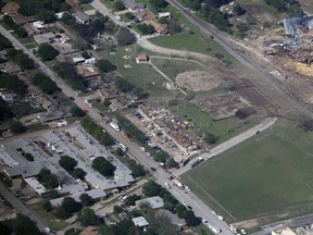 This Thursday, April 18, 2013 aerial photo shows the remains of a nursing home, left, apartment complex, center, and fertilizer plant, right, destroyed by an explosion in West, Texas. Rescuers searched the smoking remnants for survivors of Wednesday night's thunderous fertilizer plant explosion, gingerly checking smashed houses and apartments for anyone still trapped in debris while the community awaited word on the number of dead. Initial reports put the fatalities as high as 15, but later in the day, authorities backed away from any estimate and refused to elaborate. More than 160 people were hurt.  (AP Photo/Tony Gutierrez)