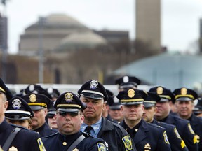 In a photo provided by Massachusetts Institute of Technology, officers from numerous police agencies stand during a memorial service for fallen MIT police officer Sean Collier on the MIT campus in Cambridge, Mass., Wednesday, April 24, 2013. Collier was fatally shot on campus Thursday, April 18, 2013. Authorities allege that the Boston Marathon bombing suspects were responsible. (AP Photo/Massachusetts Institute of Technology, Dominick Reuter)
