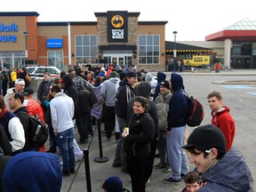 Patrons line up to be the first through the doors of the new Buffalo Wild Wings restaurant at the Devonshire Mall in Windsor, Ontario on April 8, 2013.  (JASON KRYK/The Windsor Star)