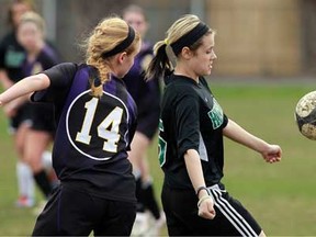 Kingsville's Sarah Denotter, left, and Herman's Sidney Wright battle for the ball during high school soccer action at Herman Secondary School in Windsor on Tuesday, April 16, 2013.                            (TYLER BROWNBRIDGE/The Windsor Star)