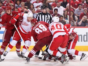 Phoenix's Rostislav Klesla, left, attempts to control the puck under pressure from Detroit's Johan Franzen at Jobing.com Arena on April 4, 2013 in Glendale, Ariz. (Christian Petersen/Getty Images)