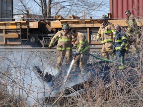 Windsor fire crews battle a small fire along the train tracks near the E.C. Row Expressway and Lauzon Road on April 5, 2013. (ADAM D'ANDREA/The Windsor Star)