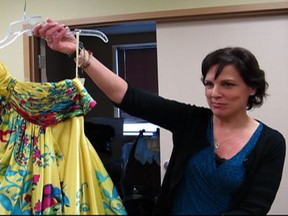 New Beginnings Executive Director Mary Kay Morand holds one of the nearly 400 dresses donated to the "Say Yes to the Dress" event. (Taylor Renkema/ The Windsor Star)