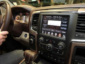 Jason Bray of Pinnacle Chrysler displays a multitude of features in the media centre, including 8.4-inch screen in Ram 1500 Longhorn April 8, 2013. (NICK BRANCACCIO/The Windsor Star)