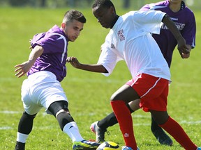 Assumption College Catholic High School's Shahram Khestro defends agains J.L. Forster Secondary School's Mohamed Ahmed Abdifatah at Assumption College in Windsor on Monday, April 22, 2013.                            (TYLER BROWNBRIDGE/The Windsor Star)