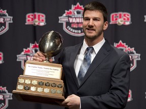 McMaster University quarterback Kyle Quinlan poses with the Hec Crighton trophy during the CFL awards in Toronto Thursday, November 22, 2012. THE CANADIAN PRESS/Sean Kilpatrick
