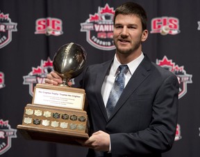 McMaster University quarterback Kyle Quinlan poses with the Hec Crighton trophy during the CFL awards in Toronto Thursday, November 22, 2012. THE CANADIAN PRESS/Sean Kilpatrick