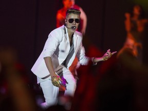 A Sunday, March 31, 2013 photo from files showing Canadian singer Justin Bieber performing on stage during the "I Believe Tour " in Berlin, Germany. (AP Photo/Gero Breloer)