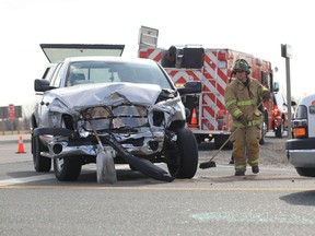 Tecumseh firefighters clean up following a two-vehicle accident on highway 3 at Malden Road in Tecumseh, Ontario on April 3, 2013.  Ontario Provincial Police said that injuries were considered minor and they continue their investigation.  (JASON KRYK/The Windsor Star)