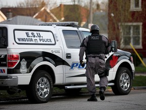 A Windsor police ESU officer leaves an apartment building at 3253 Peter St. after executing a search warrant  of one of the units Wednesday, April 24, 2013. A man was taken into custody. (KRISTIE PEARCE/The Windsor Star)