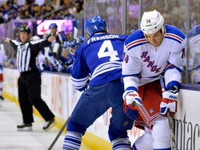 Maple Leafs defenceman Cody Franson, right, checks New York's Taylor Pyatt during first period NHL hockey action in Toronto on Monday, April 8, 2013. THE CANADIAN PRESS/Nathan Denette