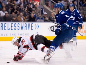 New Jersey 's Ryan Carter, left, collides with Toronto's Cody Franson during the first period in Toronto on Monday, April 15, 2013. THE CANADIAN PRESS/Frank Gunn