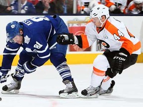 Leafs forward Phil Kessel, left, tries to get around Flyers defenceman Kimmo Timonen at the Air Canada Centre April 4, 2013 in Toronto, Ontario, Canada. (Photo by Abelimages/Getty Images)