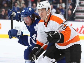 Toronto's Tyler Bozak, left, battles Philadelphia's Erik Gustafsson at the Air Canada Centre April 4, 2013 in Toronto, Ontario, Canada. (Photo by Abelimages/Getty Images)