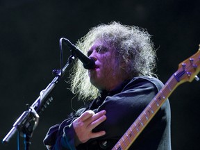 In this July 14, 2012 file photo, Robert Smith, frontman of English rock band The Cure, performs during their concert at the Optimus Alive music festival in Lisbon, Portugal. The Cure will headline the Lollapalooza music festival in Chicago's Grant Park in August 2013 for the first time in the festival's more than 20-year history. (AP Photo/Armando Franca, File)