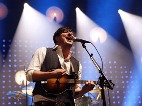 In this Feb. 6, 2013 file photo, lead singer Marcus Mumford performs with Mumford & Sons during a concert at the Barclays Center in New York. Mumford and Sons will be one of the headliners at the Lollapalooza music festival in Chicago's Grant Park in August 2013. (Photo by Jason DeCrow/Invision/AP)