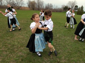 Aida Stubac (front left) and Deni Vucjak (front right) join other members of the Teutonia Club as they dance near a stake that marks the location for their maipole in Windsor on Tuesday, April 23, 2013. The Bavarian Club of Windsor will be trying to break the Guinness Book of World Records mark for the most people taking part in a May pole dance on May 4 as part of their Maifest celebrations.                           (TYLER BROWNBRIDGE/The Windsor Star)