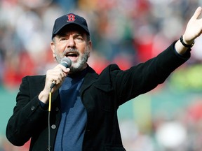 Neil Diamond sings Sweet Caroline in the eighth inning of a baseball game between the Boston Red Sox and the Kansas City Royals in Boston, on April 20, 2013. Playing at home for the first time since two explosions at the Boston Marathon finish line killed three people and wounded more than 180 others, the Red Sox honored the victims and the survivors with a pregame ceremony and an emotional video of scenes from Monday's race. (Michael Dwyer)/Associated Press)