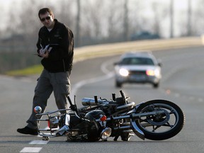 Windsor police investigate at the scene of a motorcycle accident in the eastbound lanes of E.C. Row near Howard Avenue in Windsor on Friday, April 26, 2013.                            (TYLER BROWNBRIDGE/The Windsor Star)