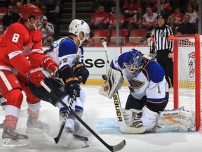 Essex native Dan O'Halloran, back right, looks on as Detroit's Justin Abdelkader, left, and St. Louis' Alex Pietrangelo crash the net of Blues goalie Brian Elliot at Joe Louis Arena April 7, 2013 in Detroit. It marked O'Halloran's 1,000th NHL game. (Dave Reginek/Getty Images)