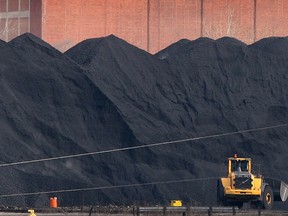 A massive pile of petroleum coke is shown on the U.S. banks of the Detroit River prior to loading aboard a freighter on April 15, 2013. (Nick Brancaccio / The Windsor Star)