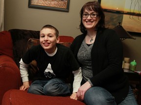 Benjamin Powers, 13, left, with his mom Diane Powers in their Tecumseh home is developmentally challenged and needs assistance with all aspects of his life. His family has entered him in an online National Mobility Awareness contest. The winning vote collectors get a much-needed wheelchair accessible van. (TYLER BROWNBRIDGE/The Windsor Star)