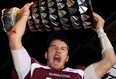 McMaster's quarterback Kyle Quinlan of South Woodslee lifts the Yates Cup after winning the OUA championship against Guelph Nov. 10, 2012. Monday. Quinlan was named CIS athlete of the year. (THE CANADIAN PRESS/Dave Chidley)