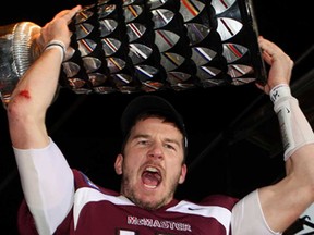 McMaster's quarterback Kyle Quinlan of South Woodslee lifts the Yates Cup after winning the OUA championship against Guelph Nov. 10, 2012. Monday. Quinlan was named CIS athlete of the year. (THE CANADIAN PRESS/Dave Chidley)