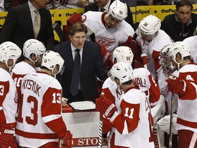 Detroit Red Wings head coach Mike Babcock, middle, talks to his players during a timeout in the third period during an NHL hockey game in this 2013 file photo. (AP Photo/Ross D. Franklin)