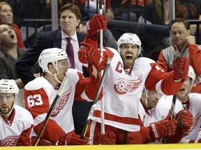 Detroit Red Wings center Henrik Zetterberg (40), of Sweden, and center Joakim Andersson (63), also of Sweden, celebrate after Johan Franzen, not shown, scored against the Nashville Predators in the third period of an NHL hockey game, Sunday, April 14, 2013, in Nashville, Tenn. At rear left is head coach Mike Babcock. The Red Wings won 3-0. (AP Photo/Mark Humphrey)