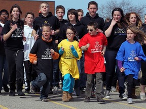 Wearing Olympic colours in the front row, Ecole Pavillon Des Jeunes students Robert Gignac, left, Karina Harvey, Patrick White and Reese Stainer run with Grade 8 team leaders during In Sports We Are One, a series of Olympic-themed events in april, 2013. (Windsor Star files)