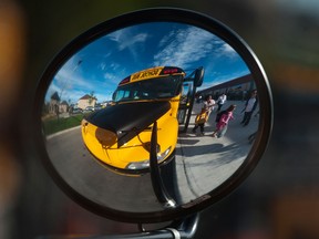 A school bus is reflected in its side mirror. (Postmedia News files)