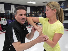 Windsor Star reporter Kelly Steele learns self-defence techniques from Lamon Kersey of Mr. Kersey's Karate School in Windsor. Here she learns to use her elbow as a weapon. (DAN JANISSE / The Windsor Star)