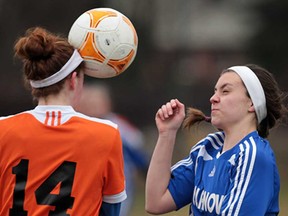 L'Essor's Elise Lariviere, left, heads the ball near Villanova's Gabby Roberts during their game Wednesday, April 10, 2013, in Tecumseh. (DAN JANISSE/The Windsor Star)